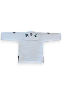 ENIGMA Kimonos white BJJ gi jacket featuring swallow embroidery on the back and reinforced cotton weave construction.