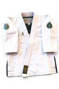 ENIGMA Kimonos white BJJ gi jacket with green botanical embroidery and interior leaf pattern lining.