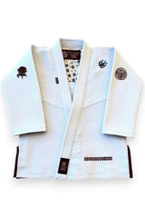 ENIGMA Kimonos white BJJ gi jacket with maroon trim, rose and swallow embroidery, and patterned interior lining.