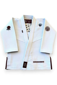 ENIGMA Kimonos white BJJ gi jacket with maroon trim, rose and swallow embroidery, and patterned interior lining.