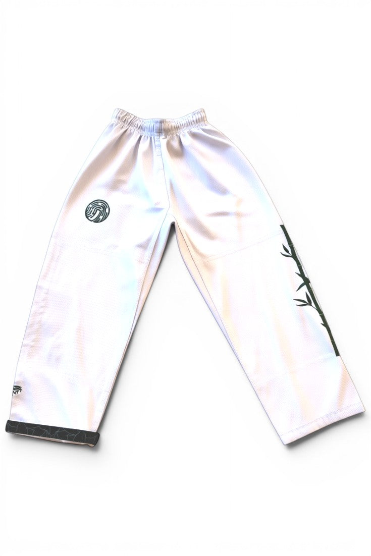 ENIGMA Kimonos white BJJ gi pants with green bamboo embroidery and circular logo detail on a white background.